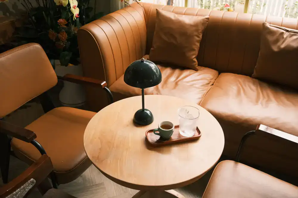 Cozy seating area with coffee cups and bicycle helmets on the table