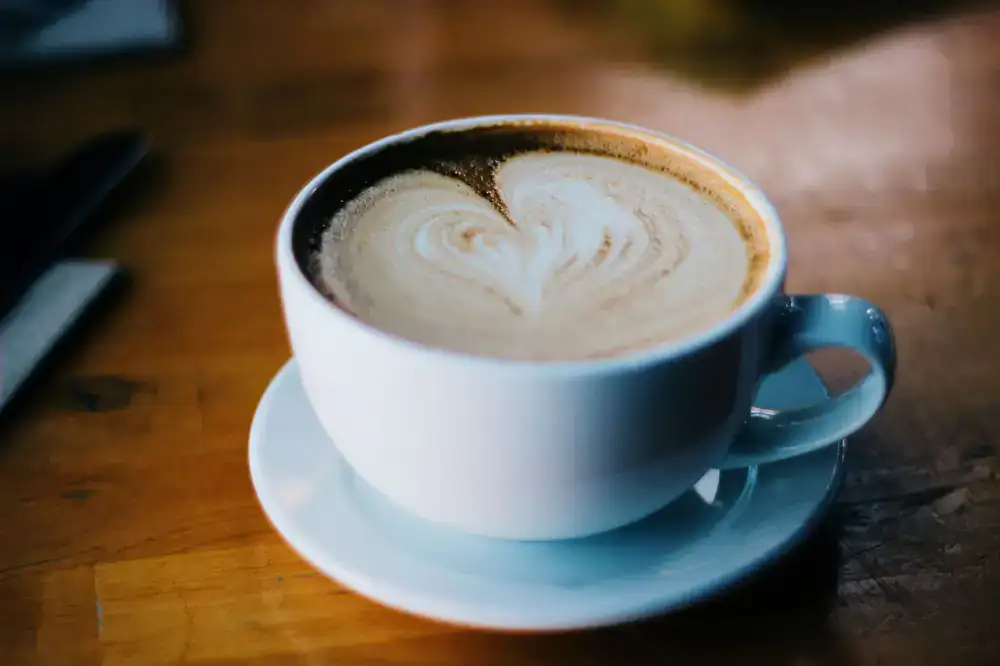 Freshly poured specialty espresso served on a wooden table